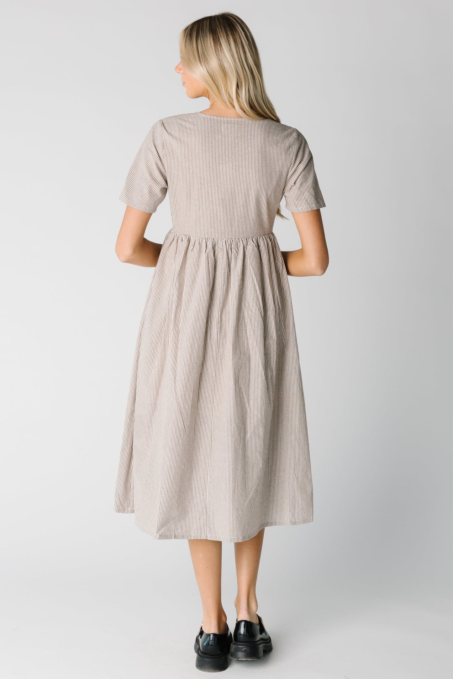 Back view of brown and white stripe midi with short sleeves