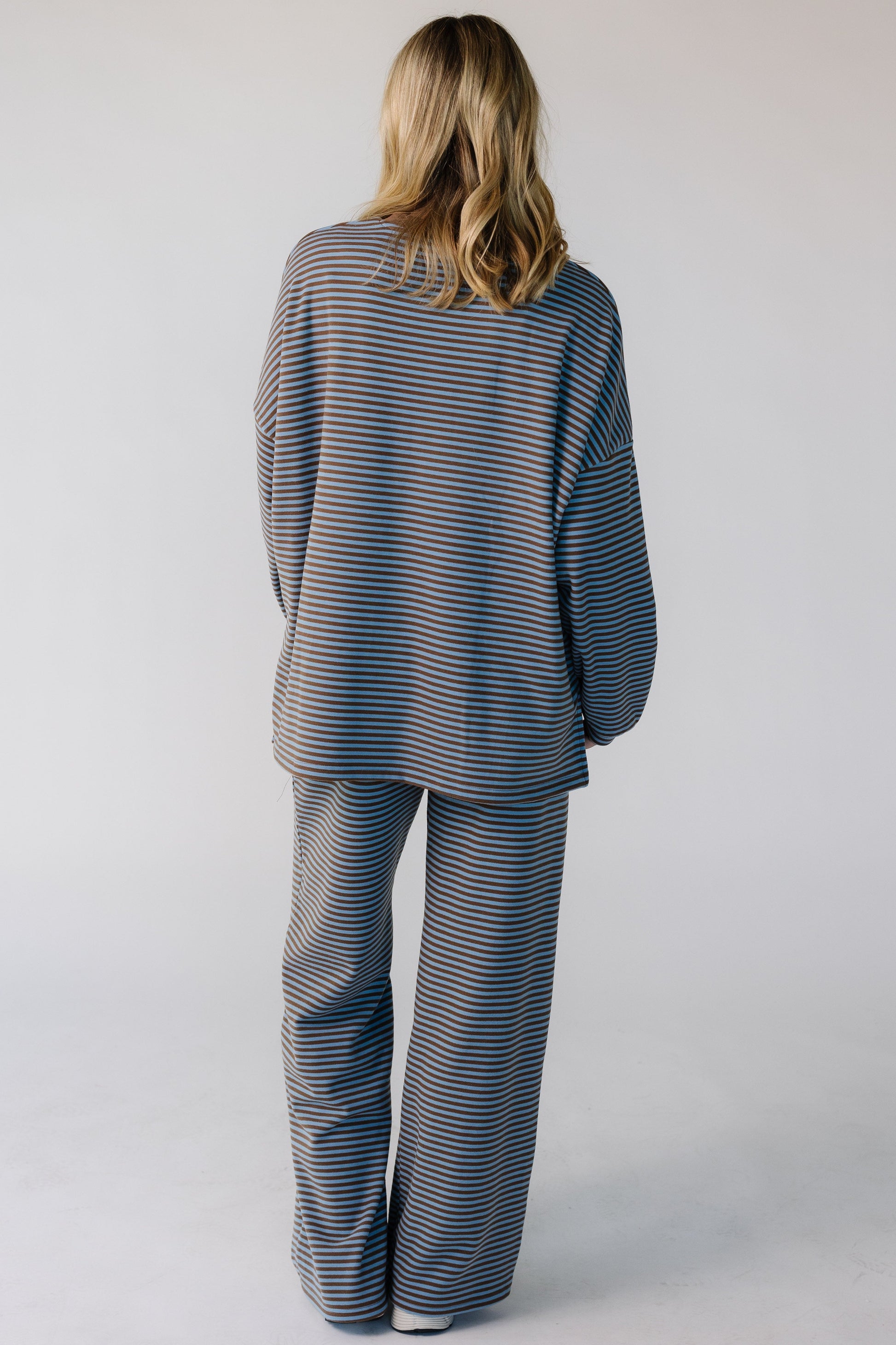 Back view of a woman wearing a light blue and brown lounge set.