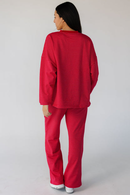 Back view of a woman wearing a modest 2 piece lounge set in red.