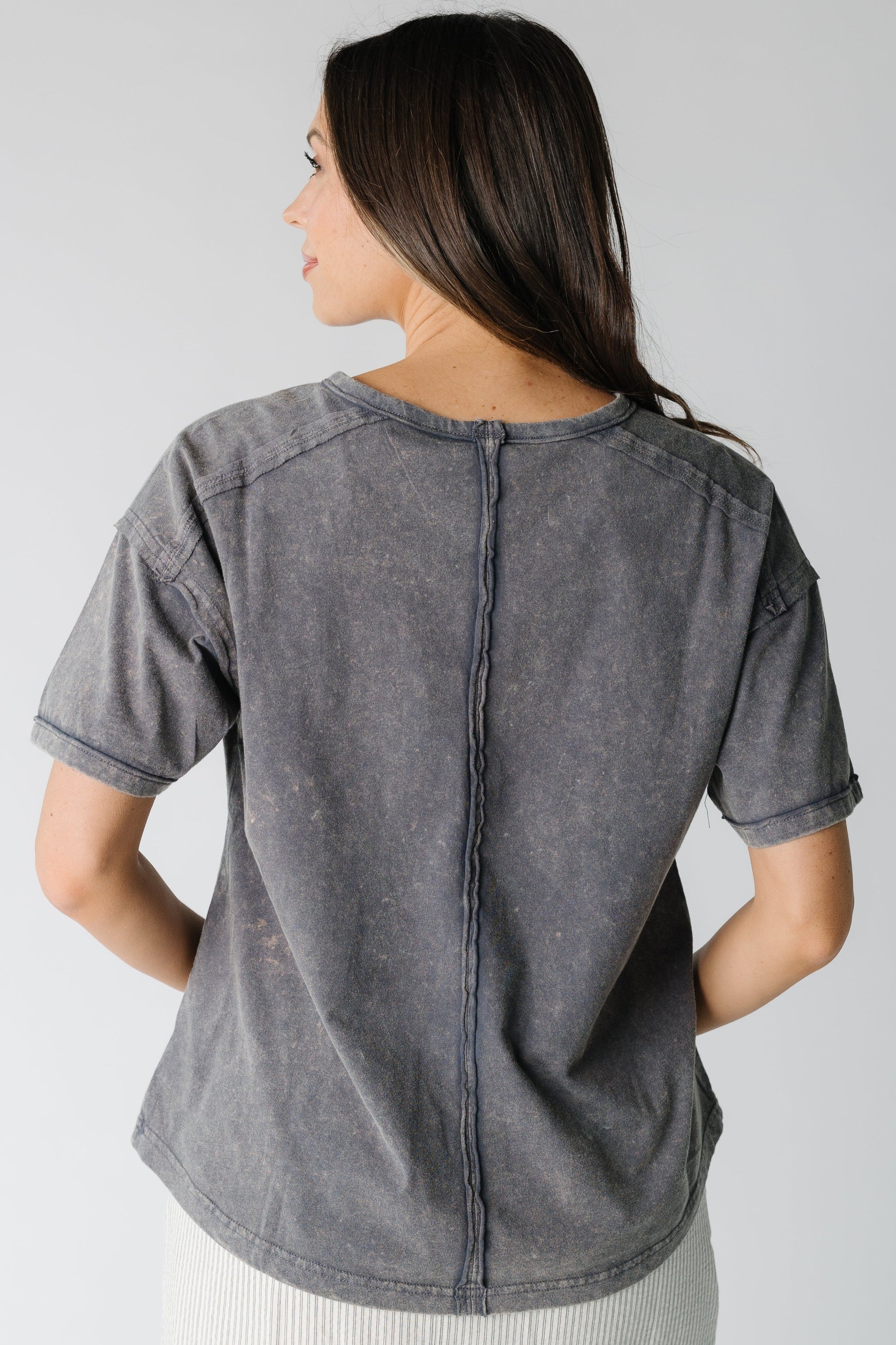 Back view of charcoal short sleeve tee with seam details