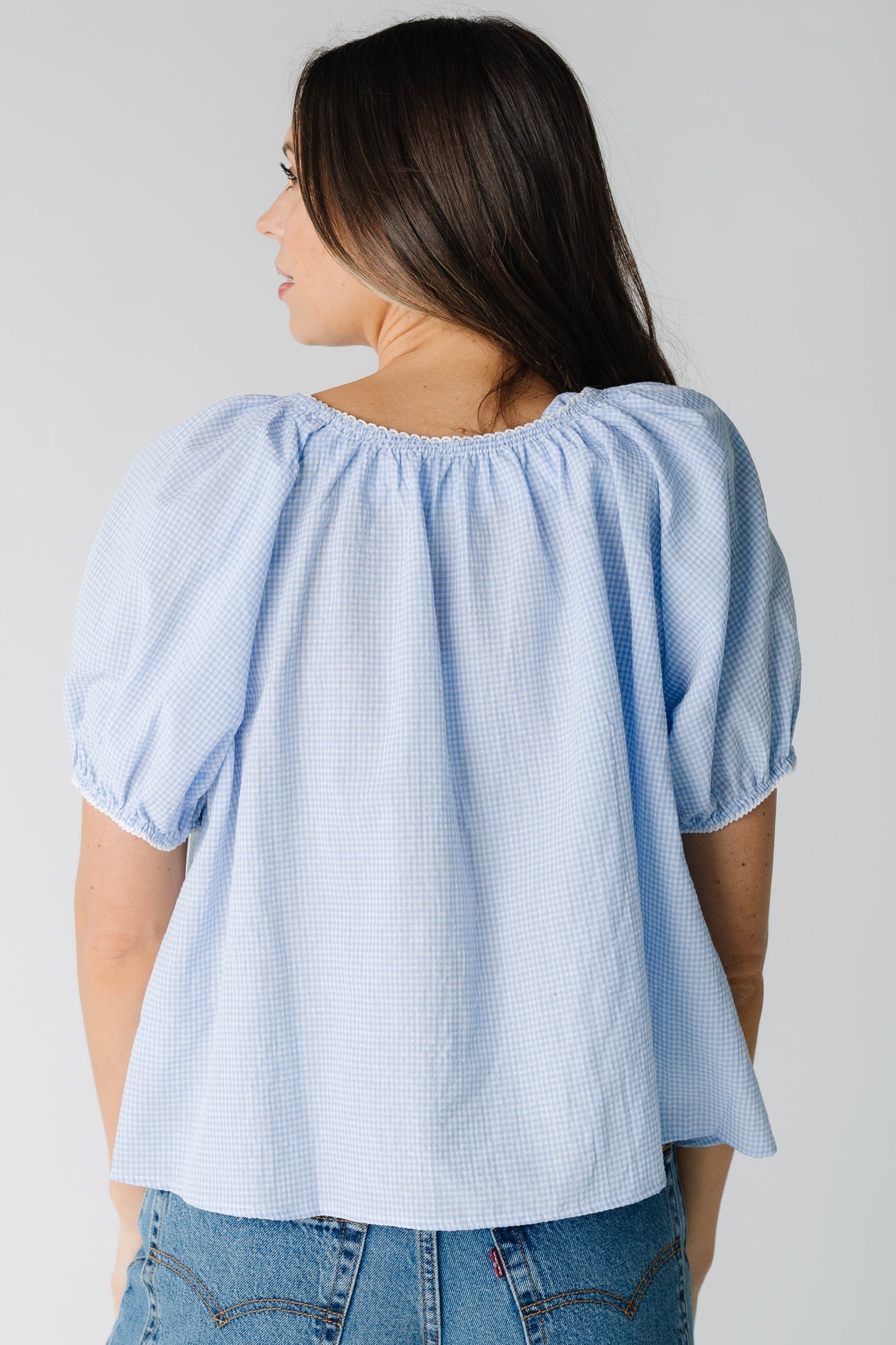 Back view of blue and white stripe top with short sleeves