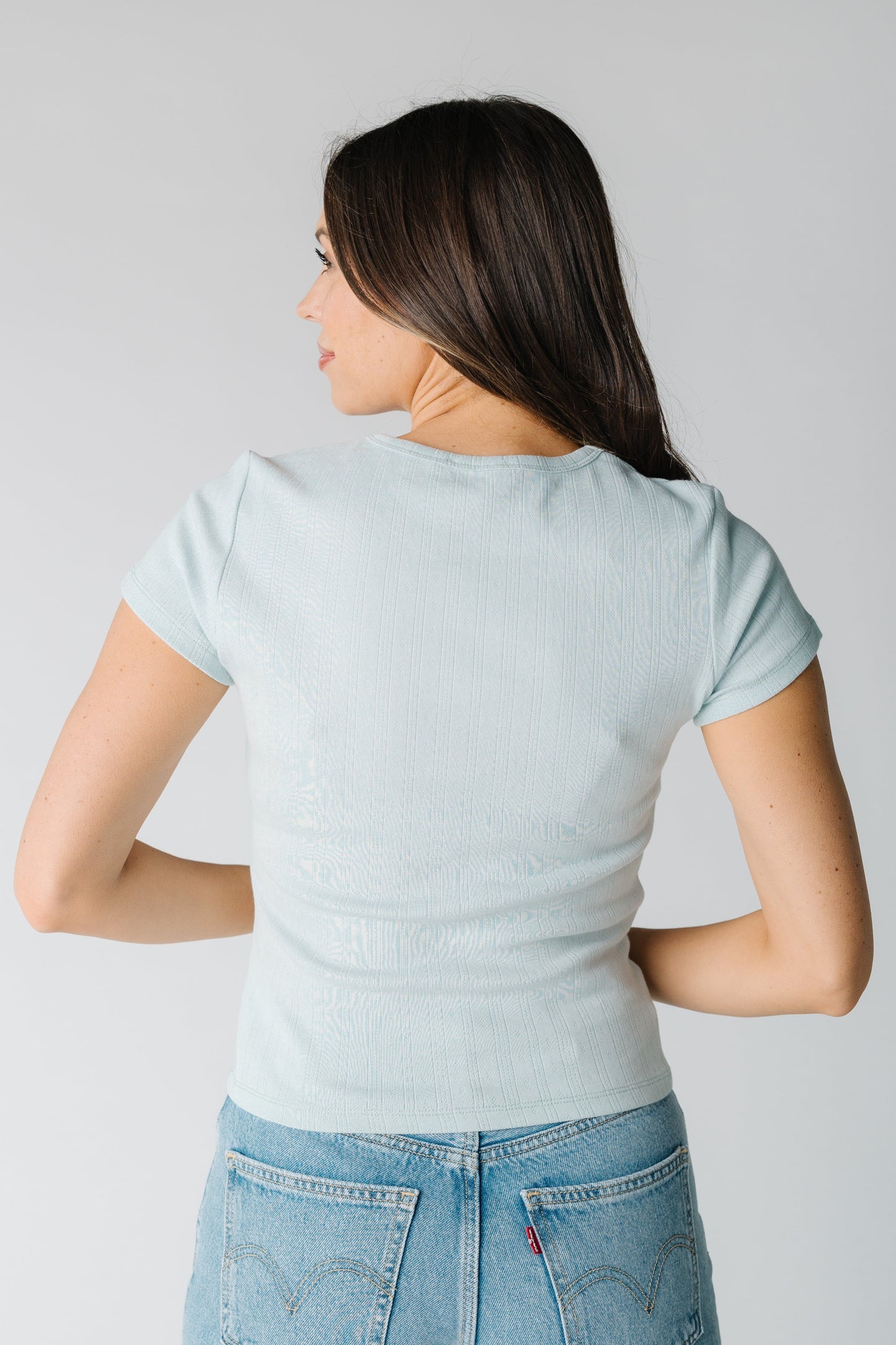 Back view of sage knit pointelle top
