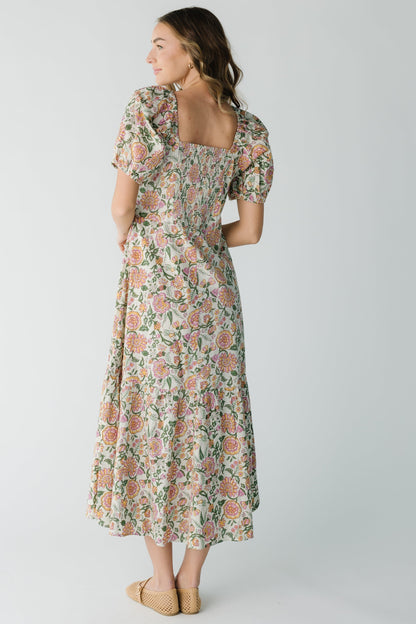 Back view of cream floral midi with square back neckline and short puff sleeves