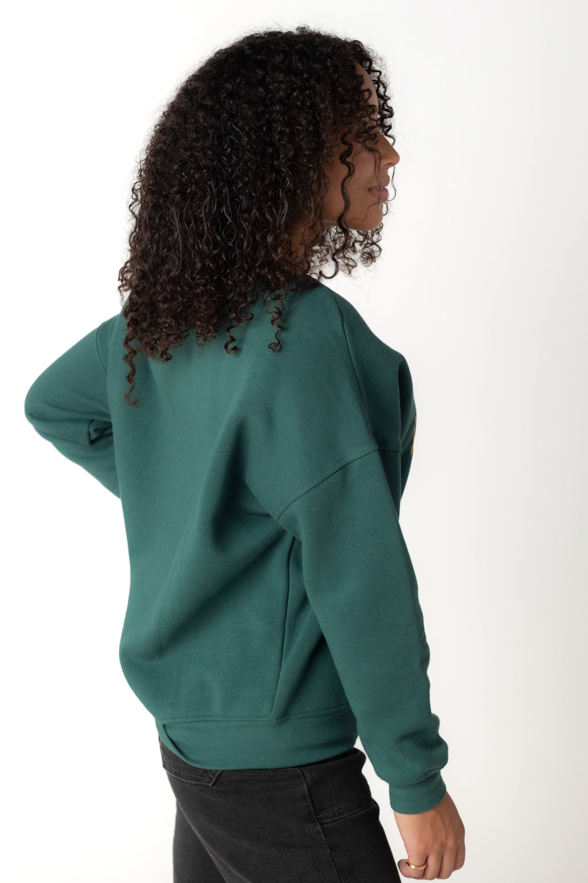 Side view of green long sleeve sweatshirt