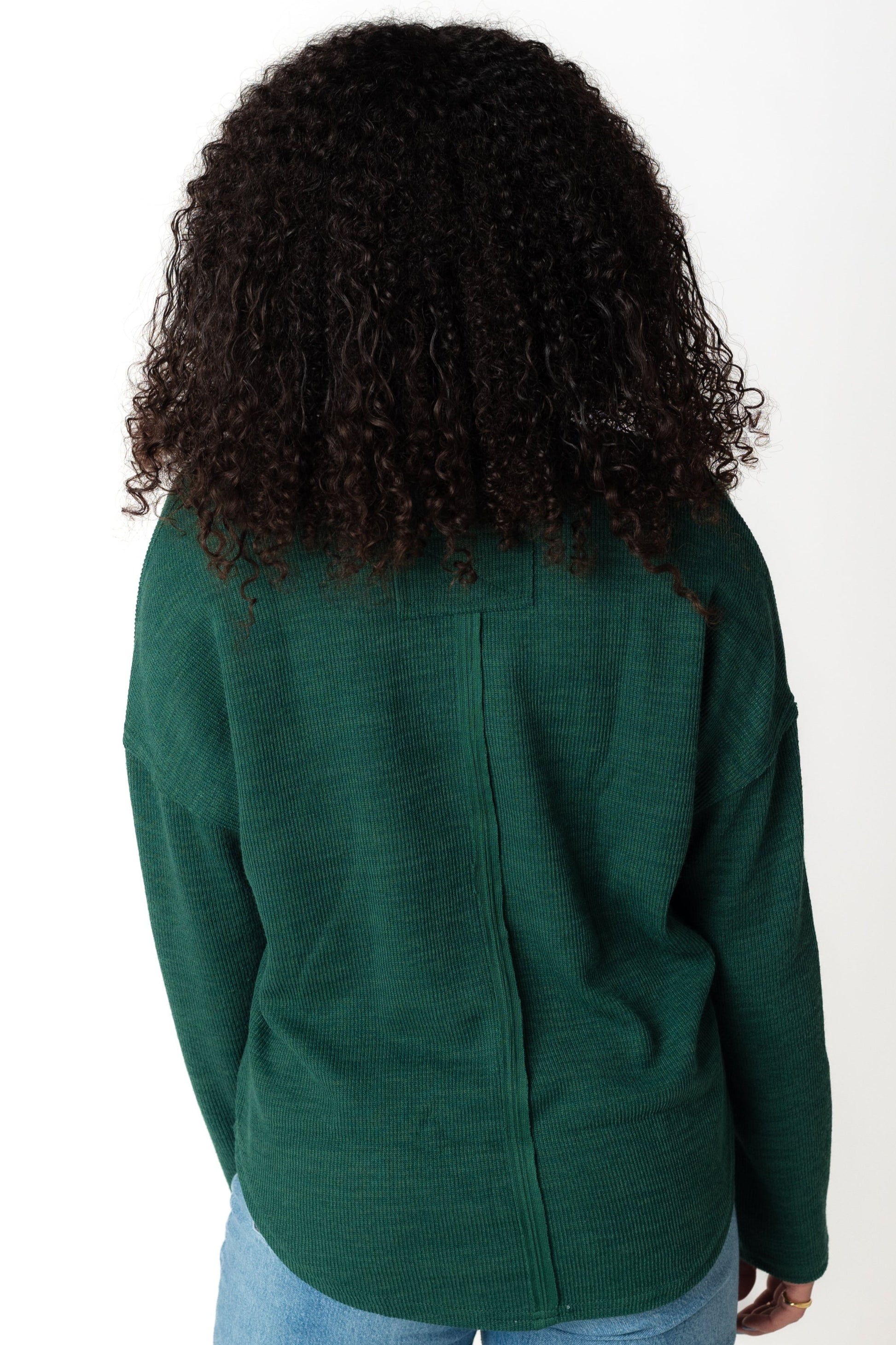 Back view of green long sleeve sweater