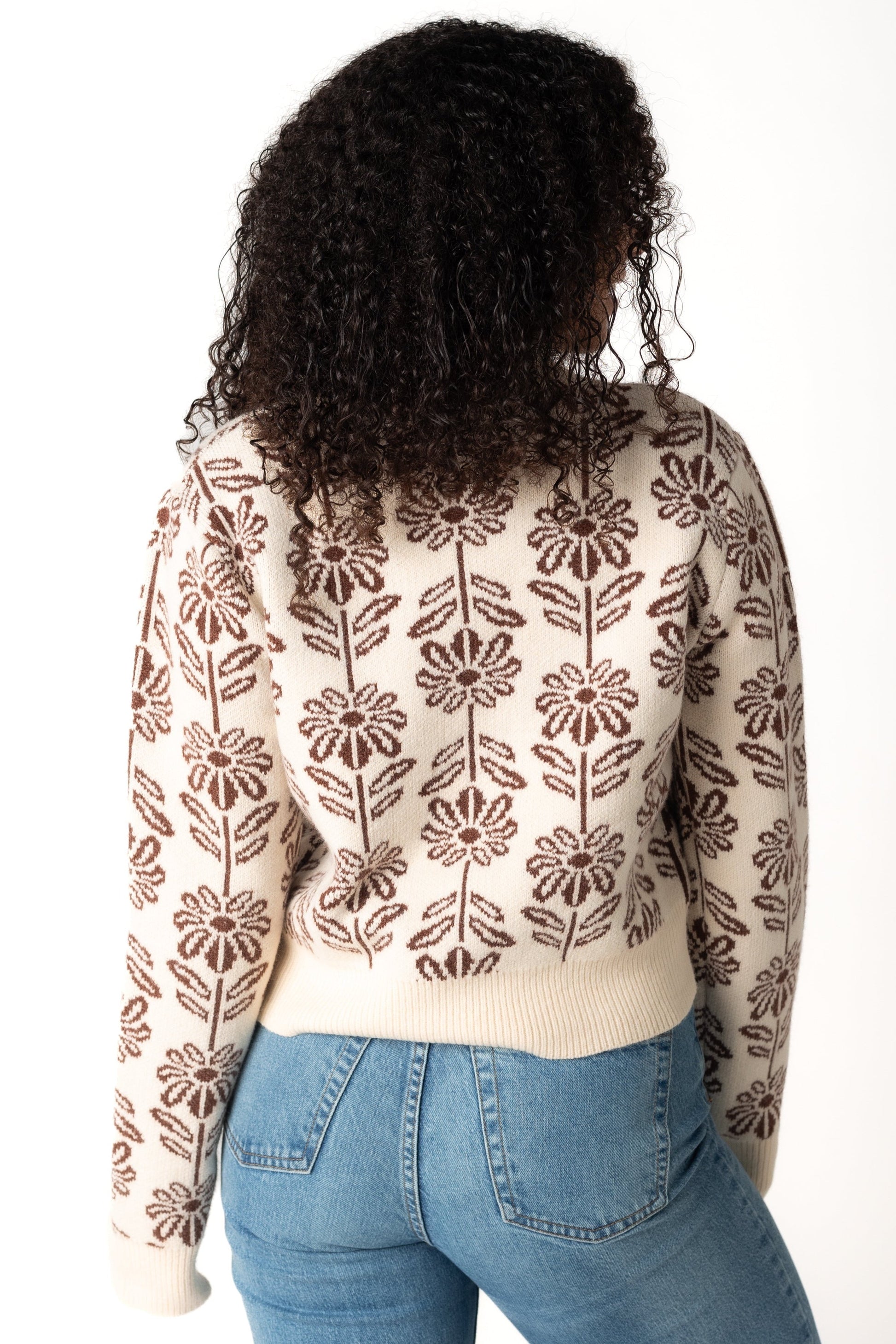 Back view of brown and cream floral sweater