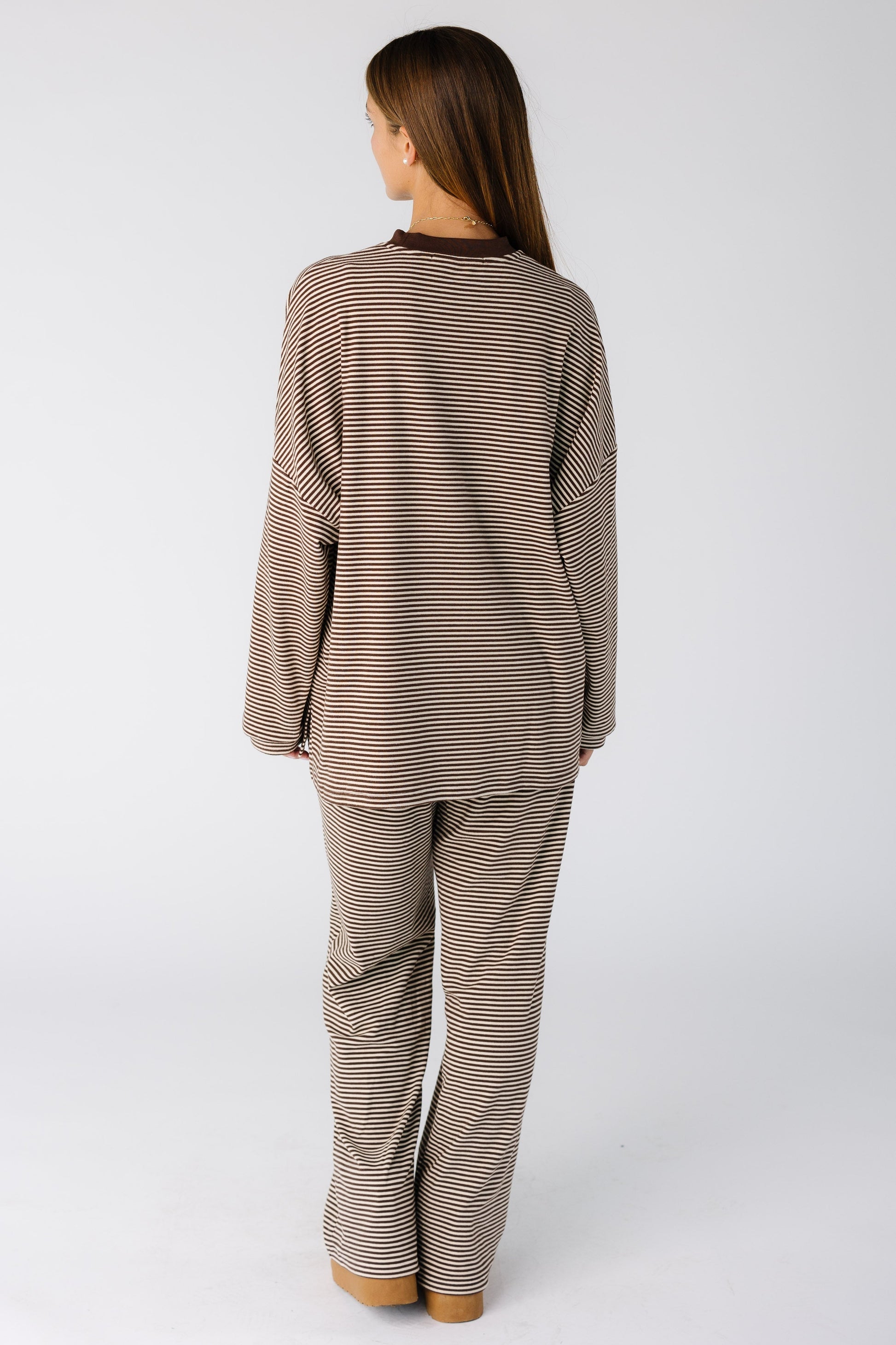 Back view of a woman wearing brown stripe lounge set