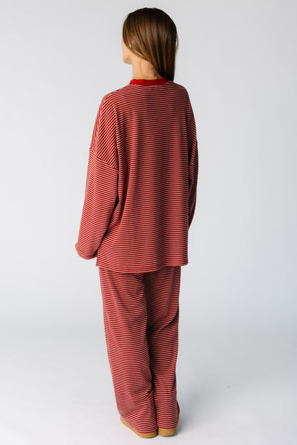 Back view of a woman wearing a red stripe lounge set with long sleeves