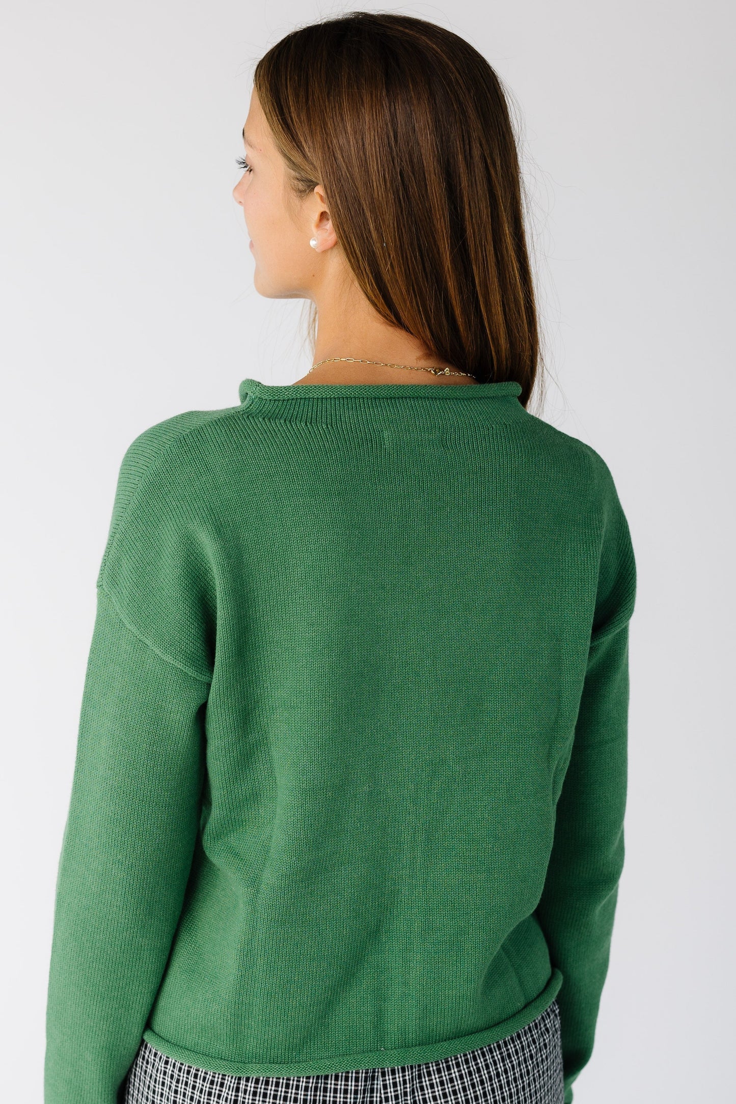 Back view of a woman wearing a green long sleeve cardigan