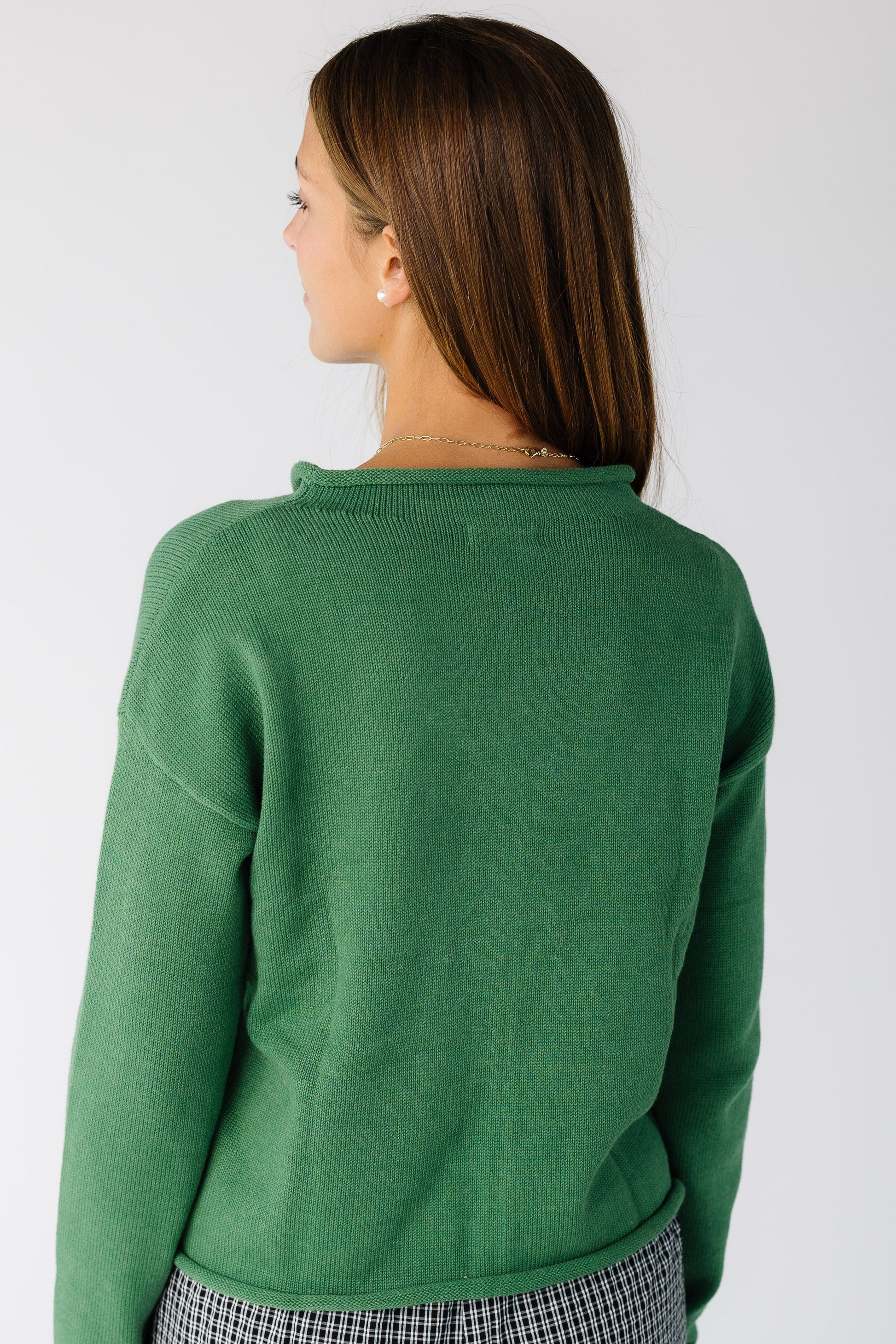 Back view of a woman wearing a green long sleeve cardigan