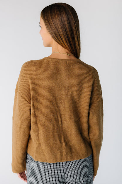 Back view of a woman wearing a brown long sleeve cardigan