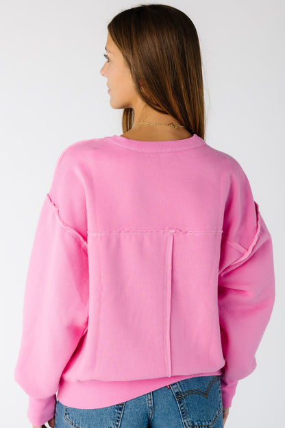 Woman wearing an exposed seam sweatshirt with long sleeves