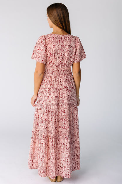 Back view of a woman wearing a pink print midi-maxi dress with short sleeves