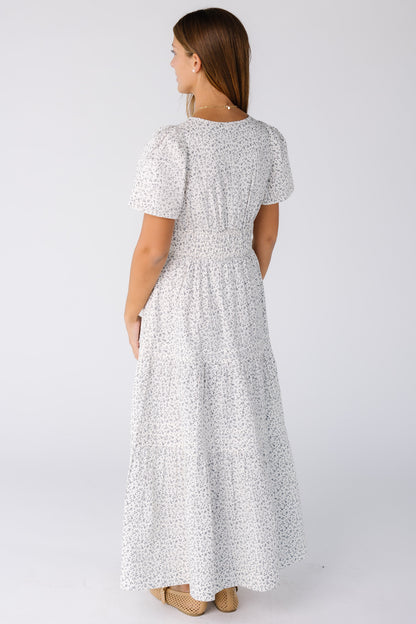 Back view of a woman wearing white print dress with short sleeves
