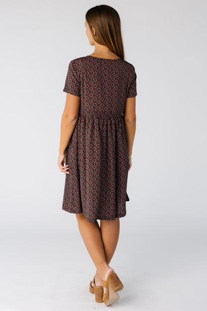 Back view of a woman wearing a knee length print dress with short sleeves