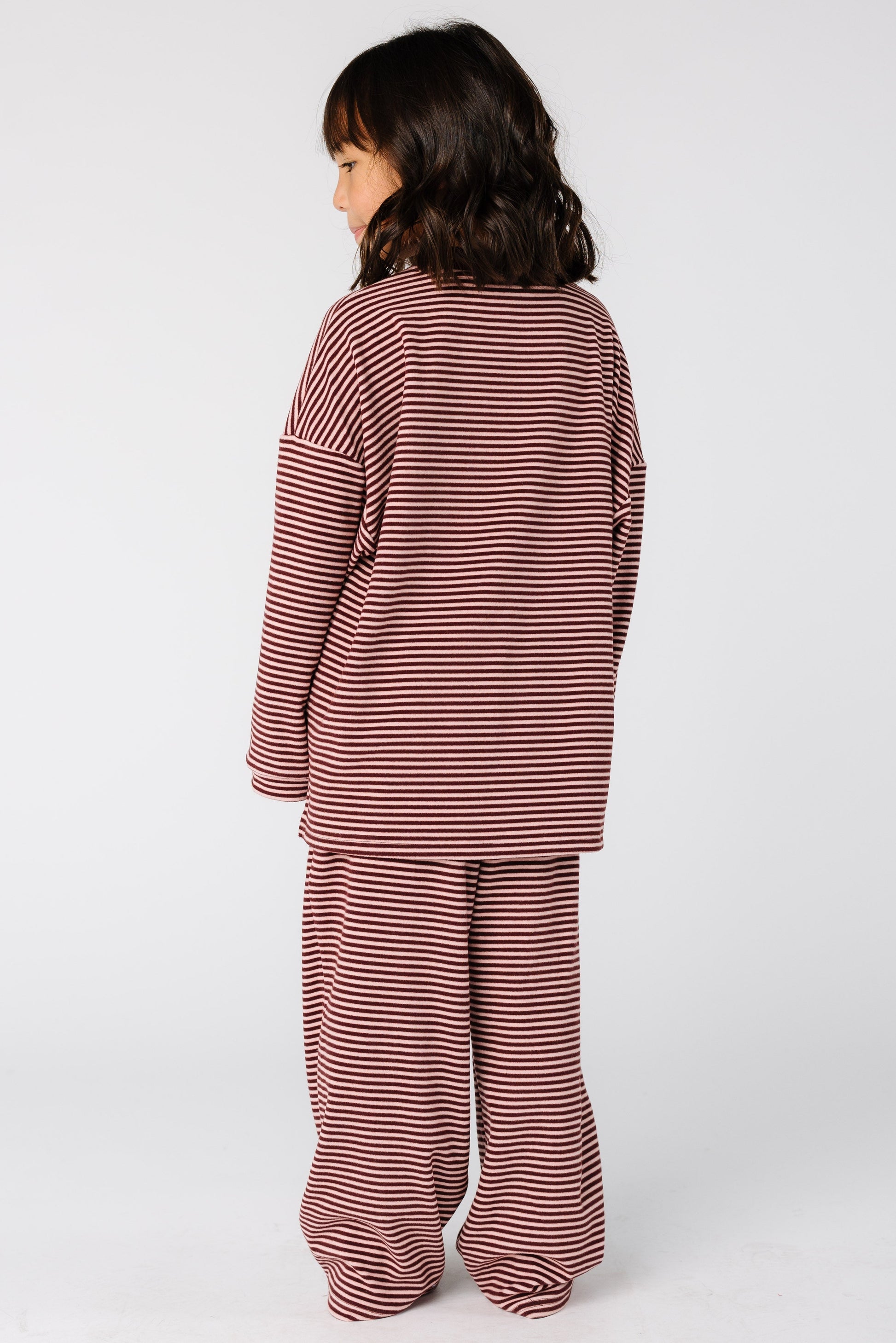 Back view of a girl wearing a loose fitting burgundy lounge set