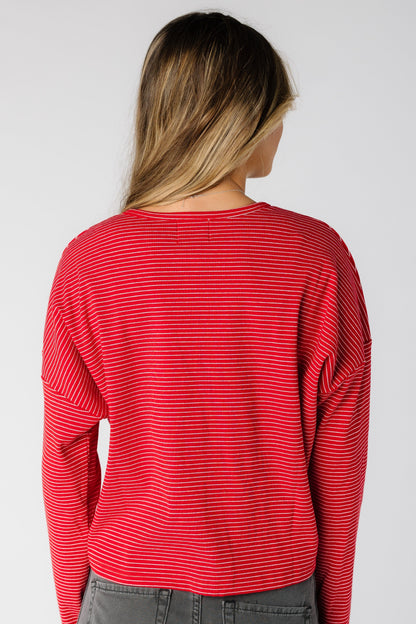Back view of a woman wearing a  red pinstripe cardigan with long sleeves