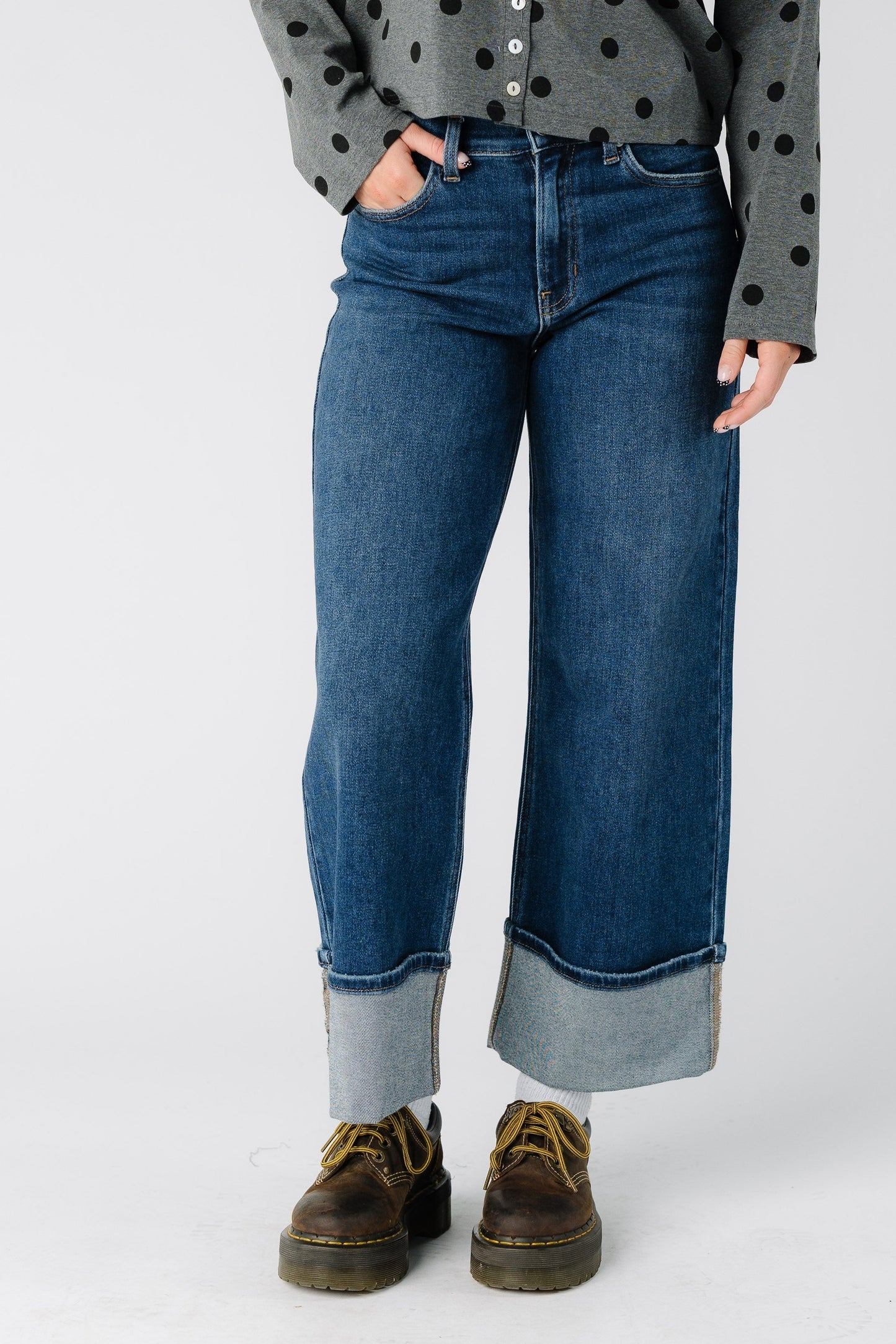 Woman wearing a modest pair of very wide jeans with mid rise and wide bottom cuffs