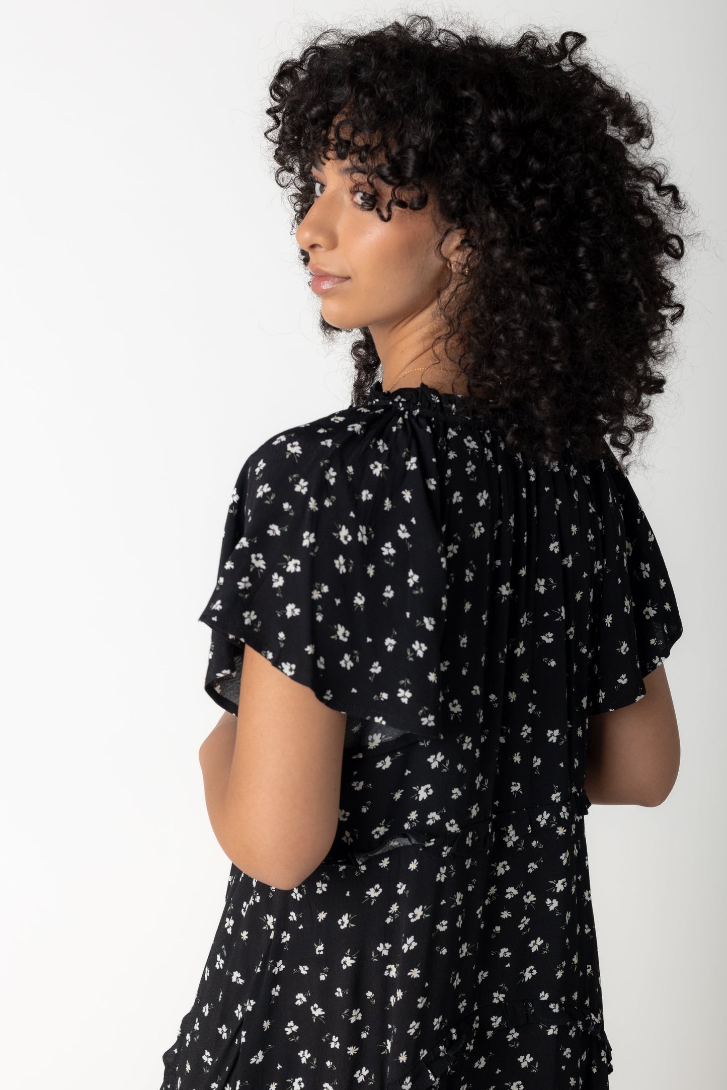 Back view of short sleeve midi dress in black floral print