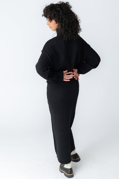 Back view of textured sweater and skirt set in black