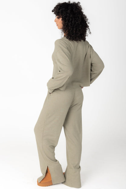 Back view of olive 2 piece lounge set with wide leg pant with side slit