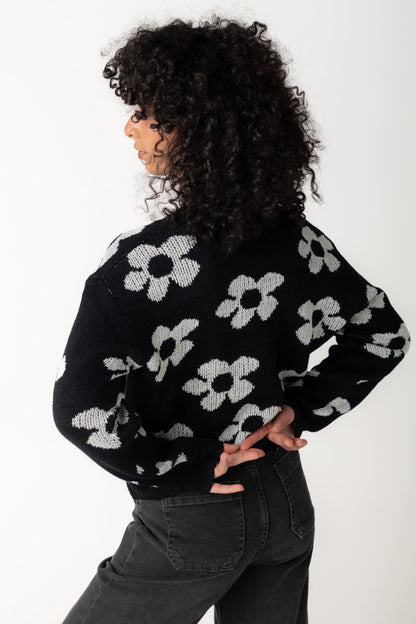 Back view of black floral sweater