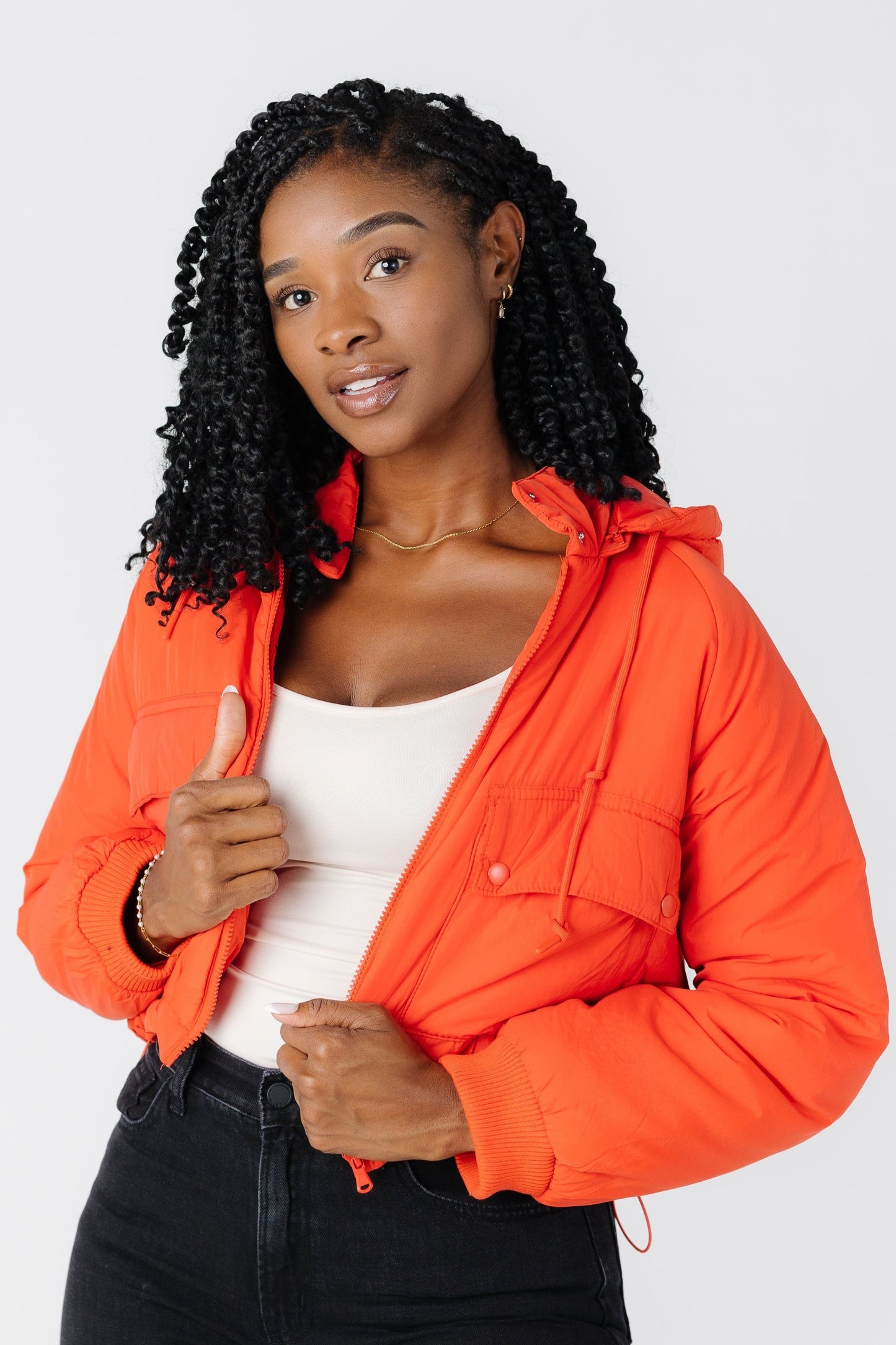 Orange puffy jacket with hood and pockets