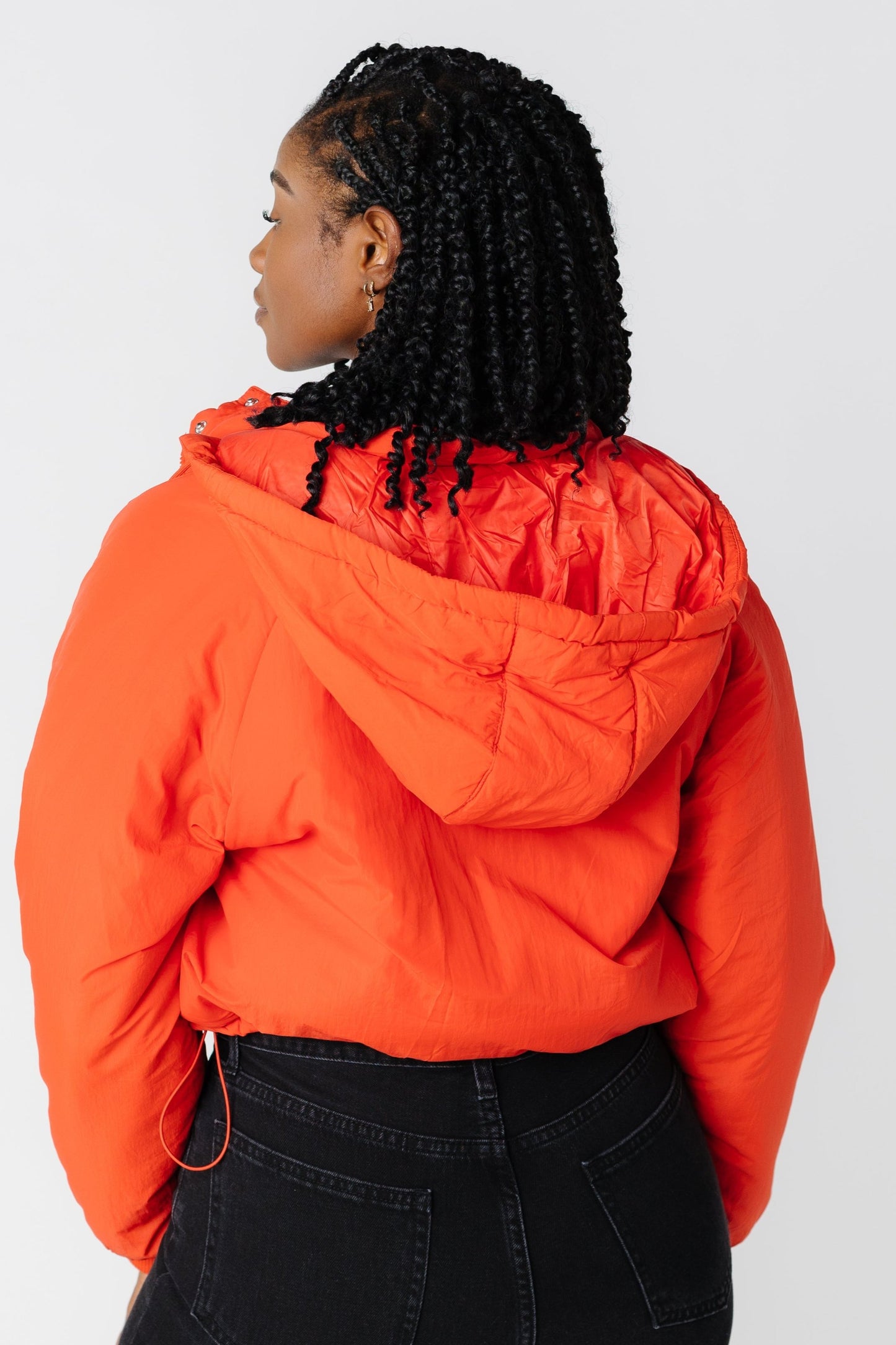 Back view of puffy orange jacket with hood 