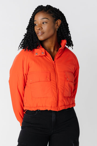 Orange puffer jacket with hood and large front pockets