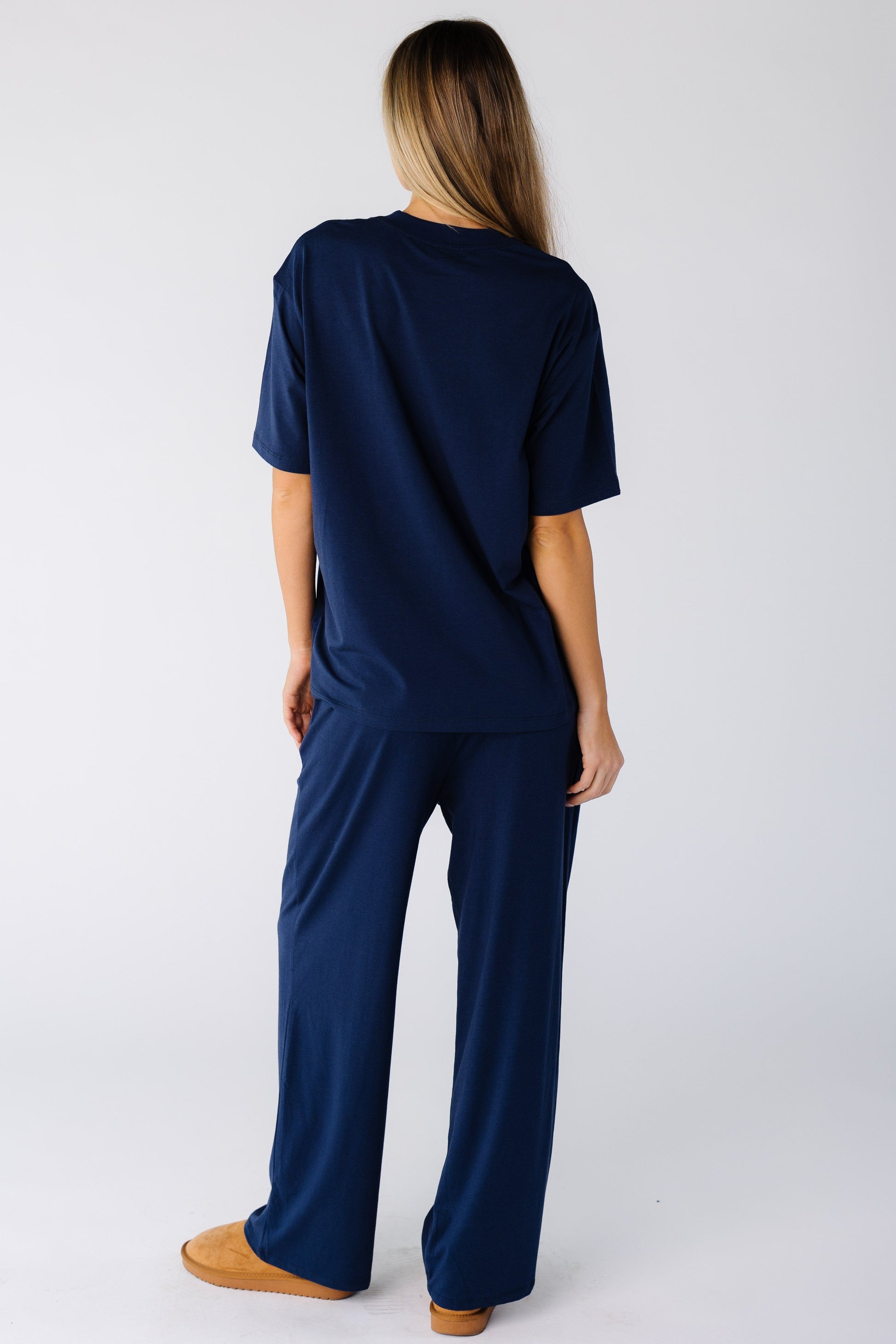 Back view of a woman wearing a 2 piece lounge set in navy