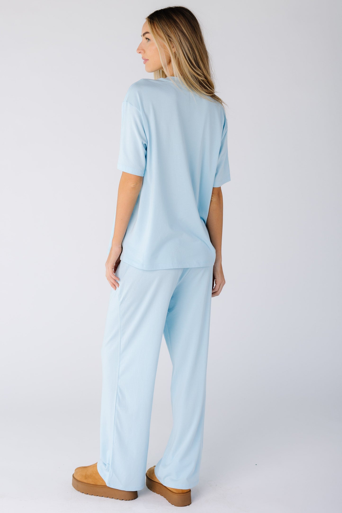 Back view of a woman wearing a light blue lounge set