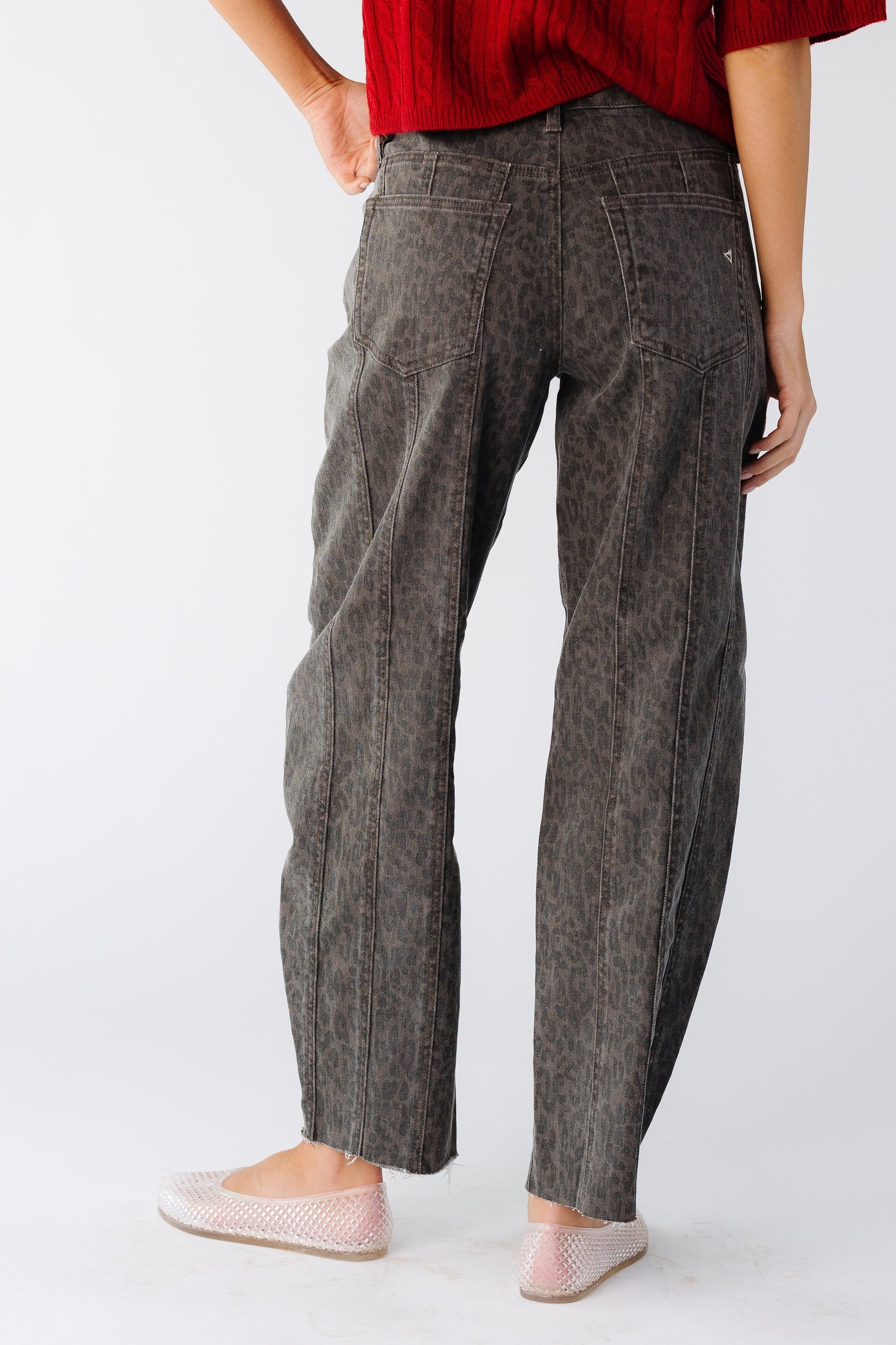 Back view of a woman wearing a pair of brown cheetah print barrel jeans