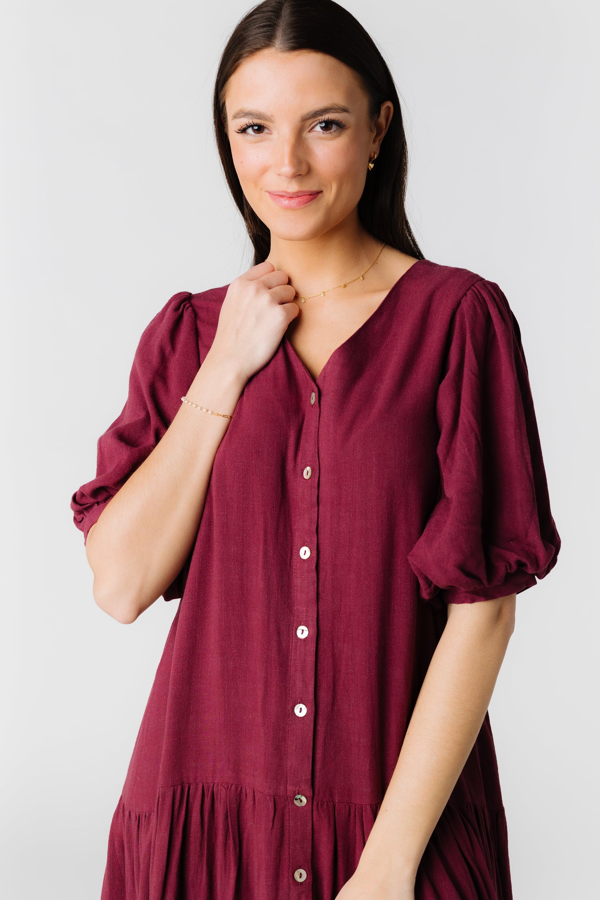 Close view of wine button down with elbow length sleeves