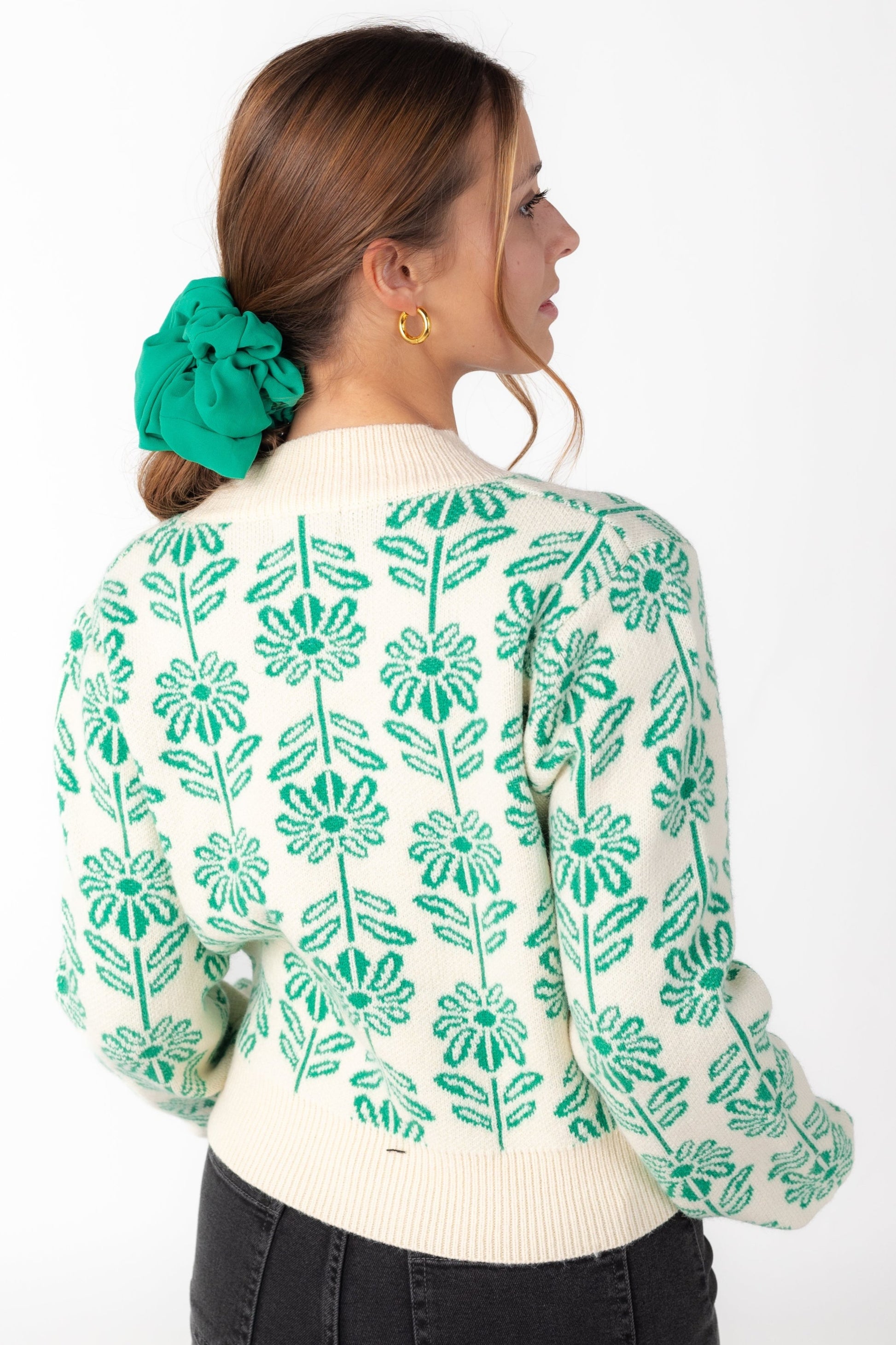 Back view of green and cream floral sweater with long sleeves