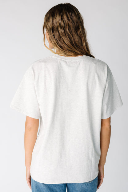 Back view of a woman wearing a light grey short sleeve tee