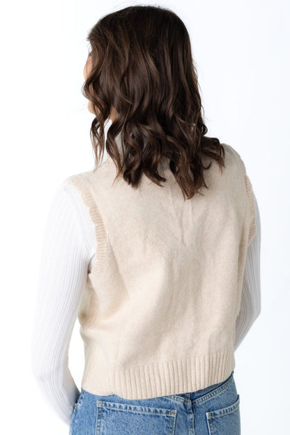 Back view of cream sleeveless sweater vest