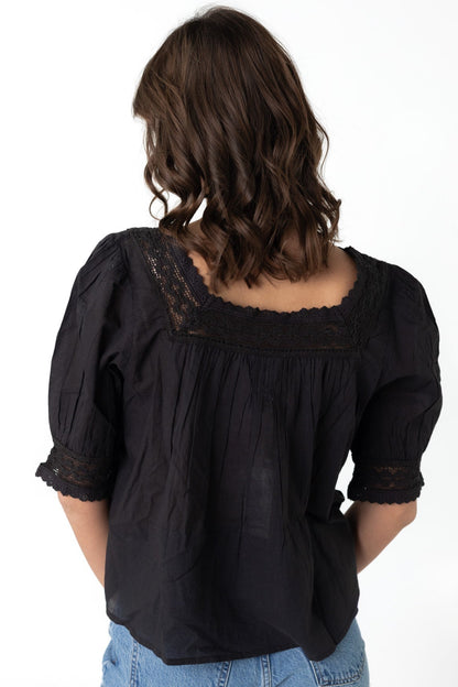 Back view of black top with square neckline and short sleeves