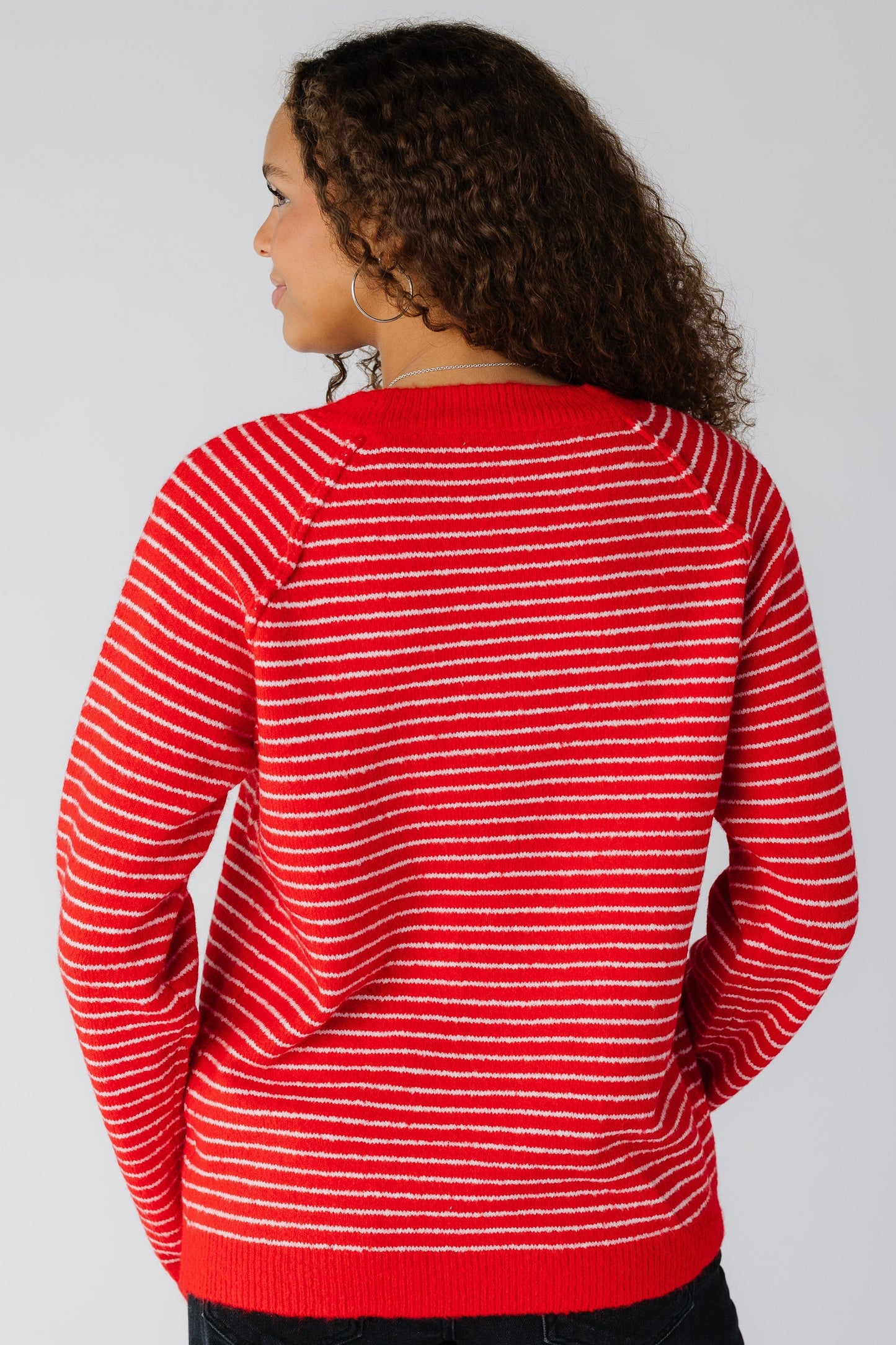 Back view of a woman wearing a red stripe pullover sweater