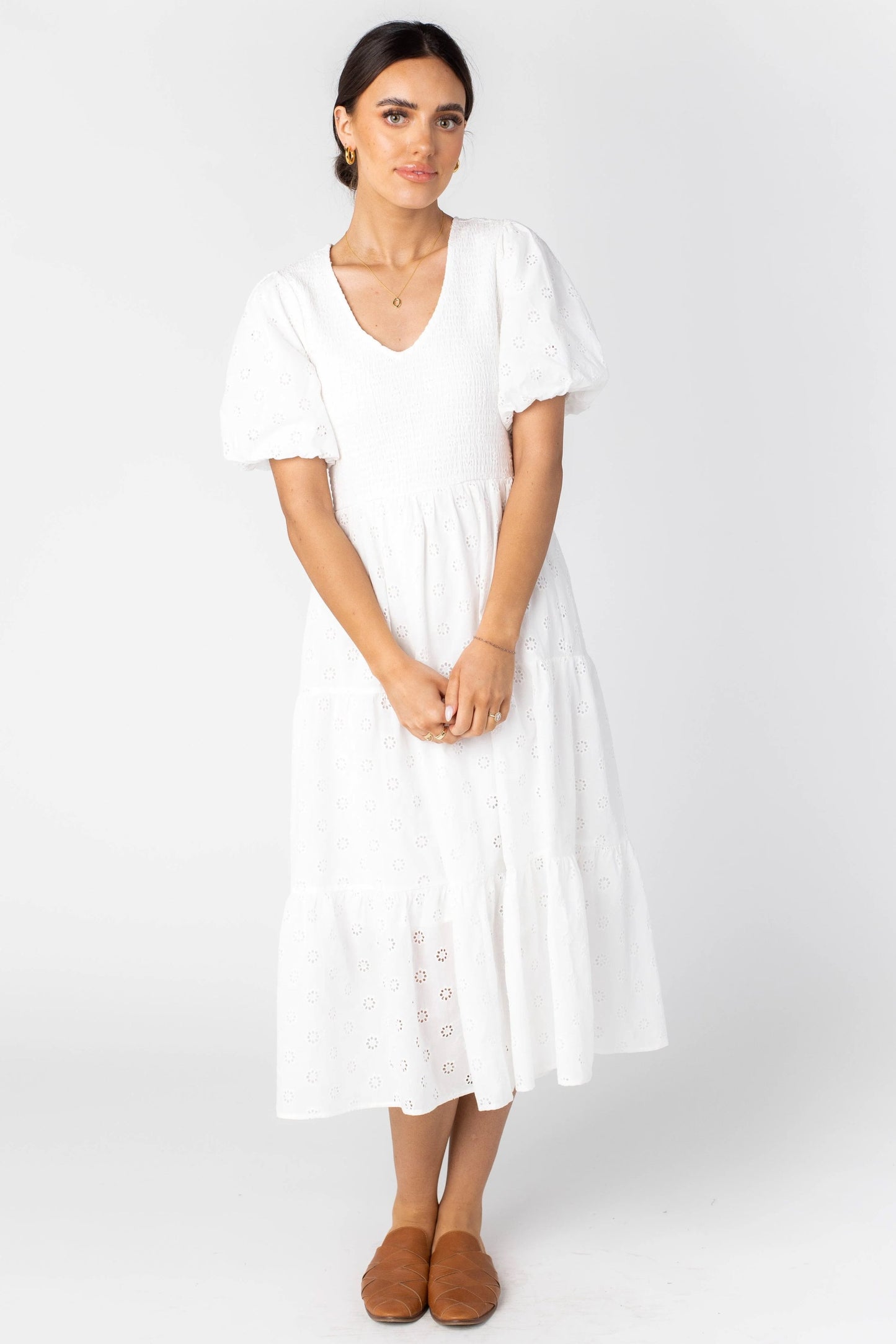 White midi dress with modest V-neckline and short full sleeves