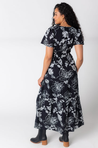 Back view of black dress with contrasting floral print and short sleeves