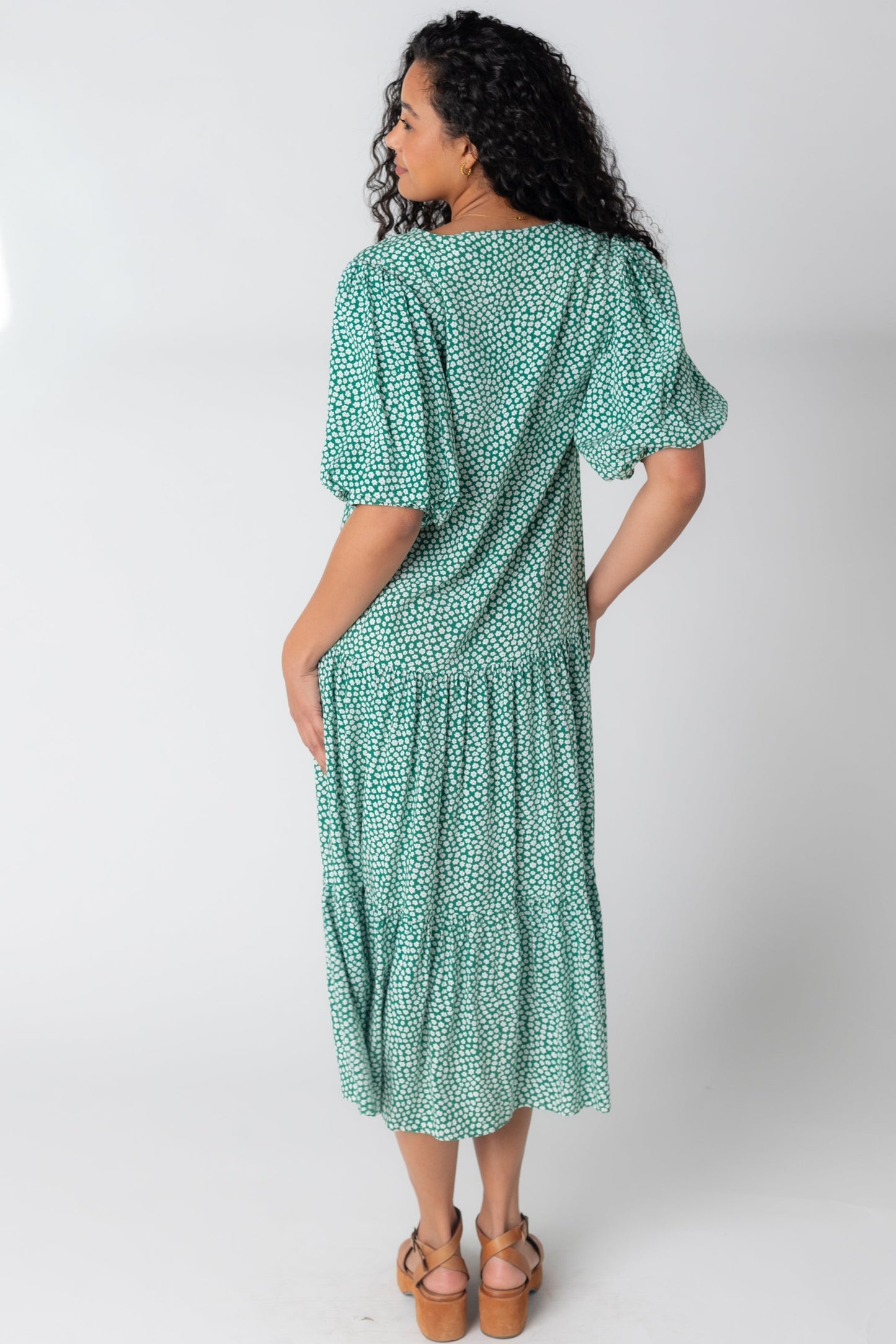 Back view of green and white print midi with half length balloon sleeves