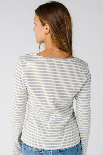 Back view of a woman wearing a ribbed stripe top in blue