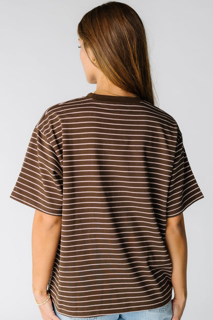 Back view of a woman wearing a brown stripe t-shirt with short sleeves
