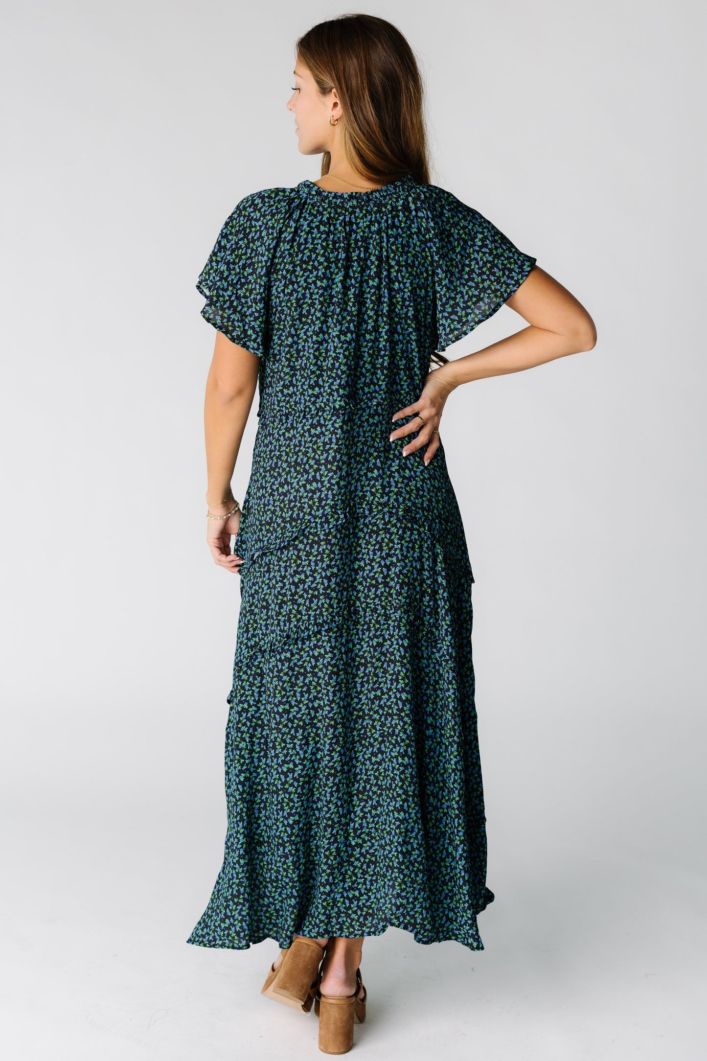 Back view of a woman wearing a blue and black floral  maxi dress