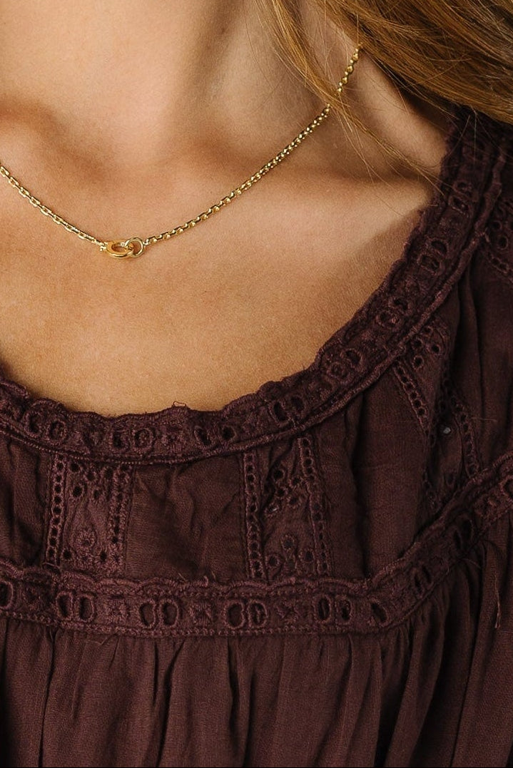Close view of a brown lace detail dress