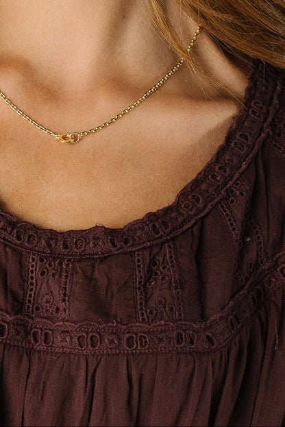 Close view of a brown lace detail dress