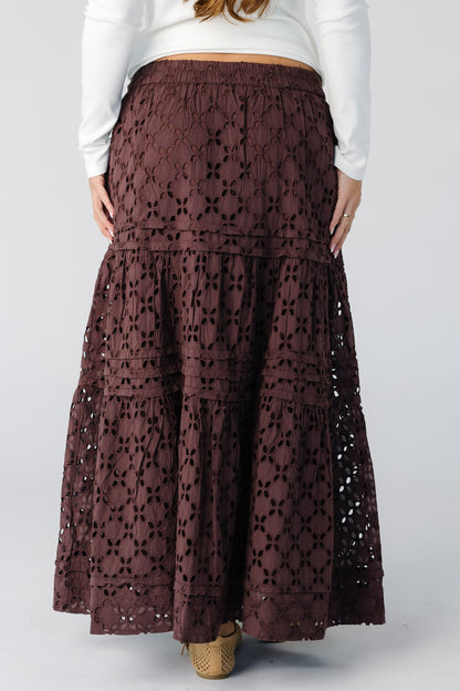 Back view f a woman wearing a brown eyelet maxi skirt
