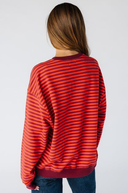 Back view of a woman wearing an oversized burgundy stripe 