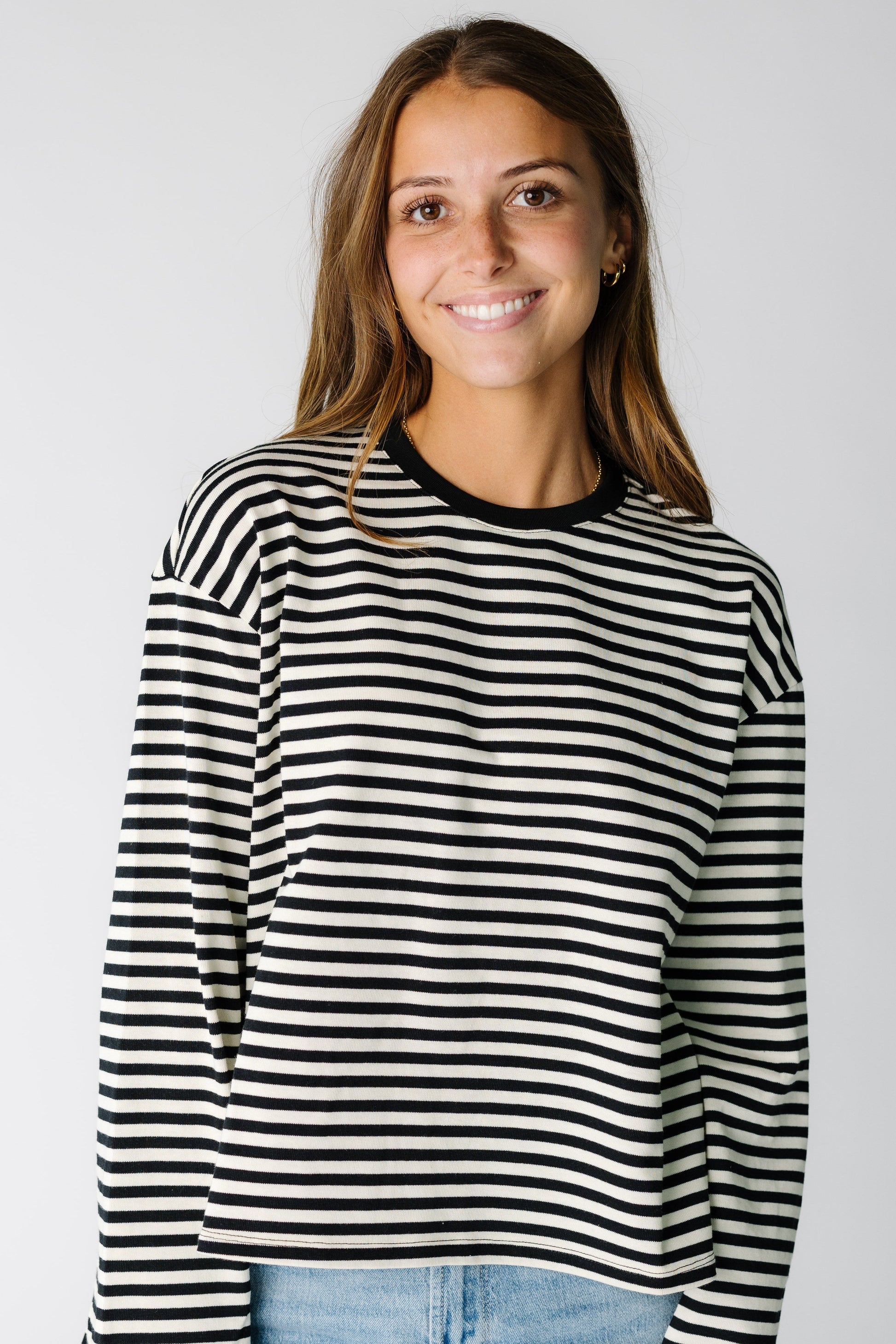 Woman wearing a black and white stripe long sleeve tee 