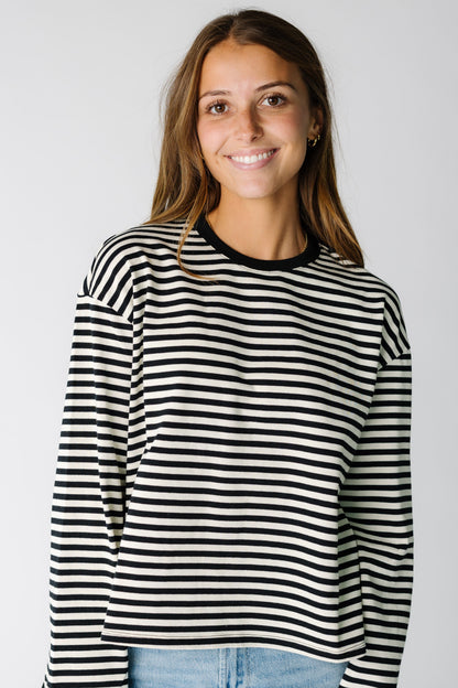 Woman wearing a black and white stripe long sleeve tee 